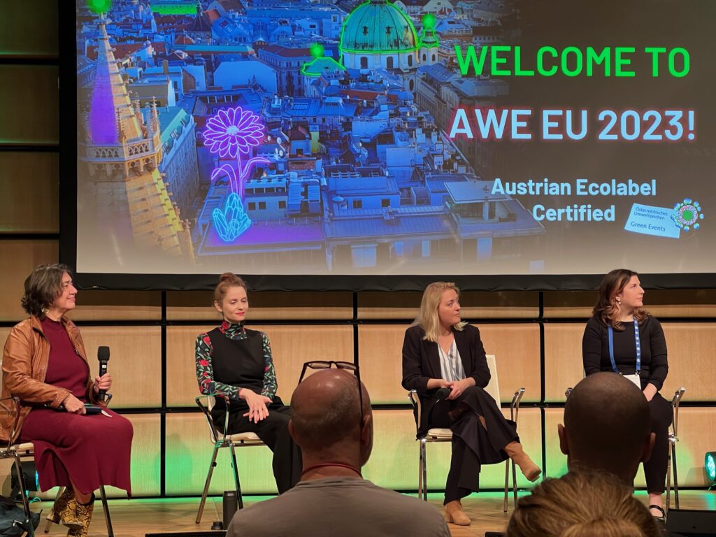 4 people sitting on a stage at the AWE EU 2023 conference.